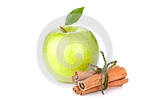 Green Apple with water drops and cinnamon sticks