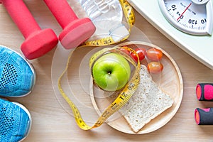 Green apple and Weight scale, measure tap with clean water and sport equipment for women diet slimming.