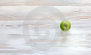 Green apple on wood background