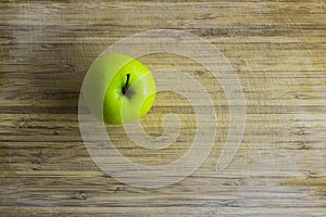 Green apple on a wooden table