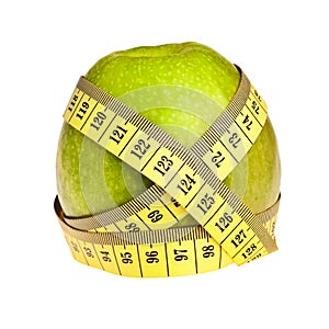 Green apple wrapped with yellow measurement tape.