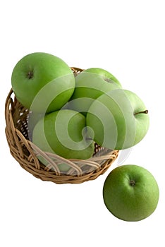 Green apples in a basket isolated