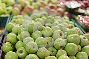 Green apples in a box in the store. green apples in boxes on market shelves. grocery shopping concept. healthy food.