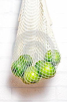 Green apples in mesh bag. Copy space.