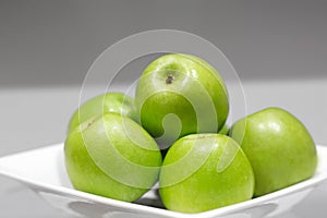 Green apples in a plate