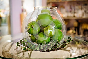 Green apples on table in vase