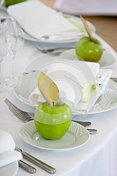 Green apples on white plates