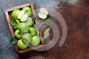 Green apples in wooden box