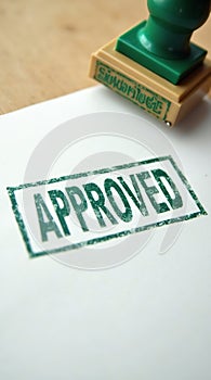 Green approved stamp on white paper background