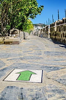 The green arrow on the floor indicates the correct direction in the castle of St. Peter. Turkey.