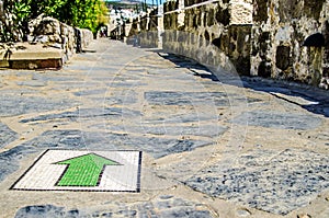 The green arrow from the mosaic on the floor indicates the right direction in the castle of St. Peter. Turkey.