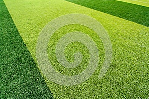 Green artificial grass soccer field for background