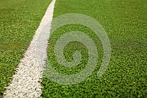 Green artificial grass soccer field. The green background.