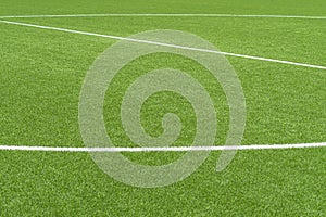 Green artificial grass soccer sports field with white stripe line