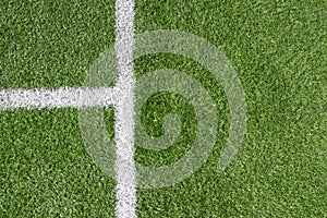 Green artificial grass turf soccer football field background with white line boundary. Top view