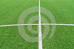 Green artificial grass turf soccer football field background with white lines. Top view