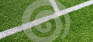 Green artificial grass turf soccer football field background with white lines. Top view