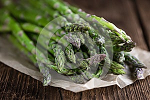 Green Asparagus (close-up shot) on wood