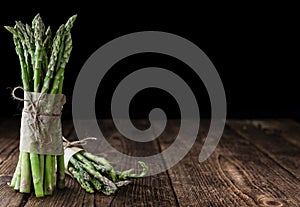 Green Asparagus (close-up shot) on wood