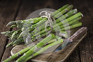 Green Asparagus (close-up shot) on wood