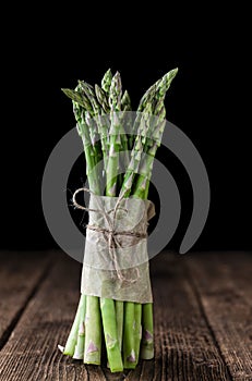 Green Asparagus (close-up shot) on wood