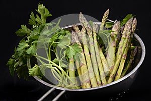 Green asparagus cut on black background