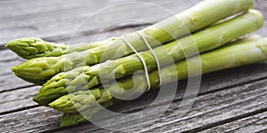 Green asparagus on gray wood