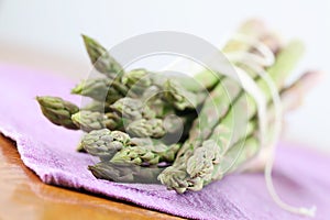 Green asparagus on purple napkin