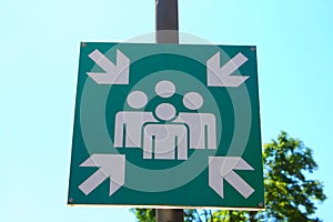 Green assembly point sign on street