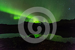 Green aurora light behind Lake mountain in southern iceland europe at national park skaftafell