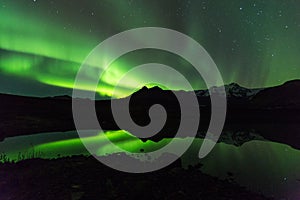 Green aurora light behind Lake mountain in southern iceland europe at national park skaftafell