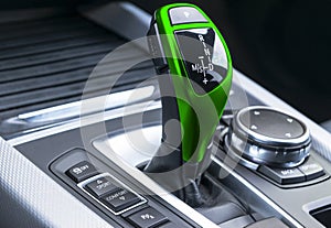 Green Automatic gear stick of a modern car. Modern car interior details. Close up view. Car detailing. Automatic transmission leve