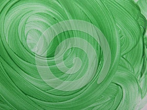 Green background of paint strokes in the form of a spiral