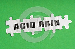 On a green background, there are puzzles on which it is written - acid rain