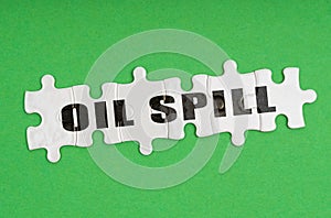 On a green background, there are puzzles on which it is written - oil spill