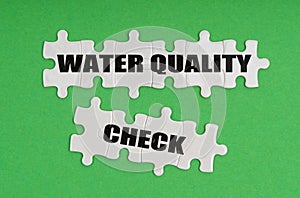 On a green background, there are puzzles on which it is written - water quality check