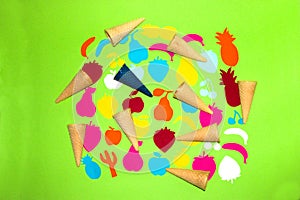 green background with various colorful paper fruits and ice cream cone, creative summer design, fresh healthy food
