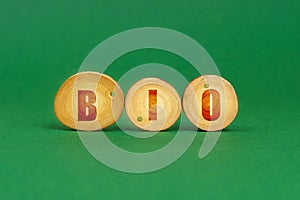 On a green background, wooden roundels with the inscription - BIO