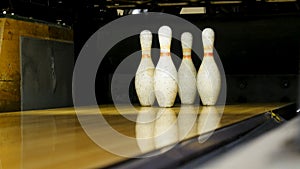 Green ball fails to hit the skittles on the playing field, activity concept. Media. Close up for several old white pins