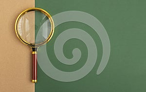 Green banner with copy space and golden magnifying glass