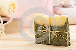 Green bar of natural organic soap with olive oil and dried herbs