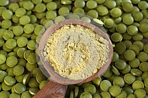 Green barley grass powder on a spoon and tablets