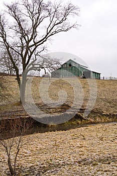 Green barn after a morning dusting