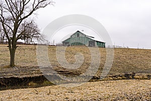 Green barn after a morning dusting