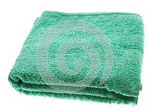green bath towel on a white background