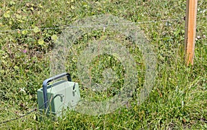 Green battery powering an electric fence