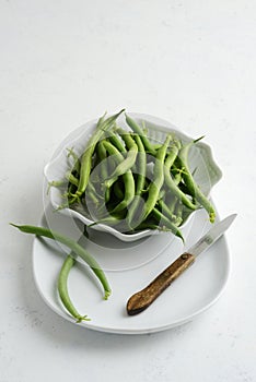 green beans in a bowl with paring knife