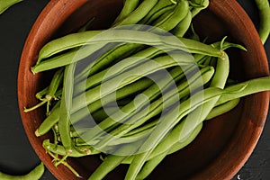 Green beans in a clay plate. Home grown. View from above. Healthy food