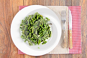 Green Beans Fried with Garlic on a White Plate