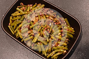 Green beans with ham. Plate of green beans cooked with serrano ham